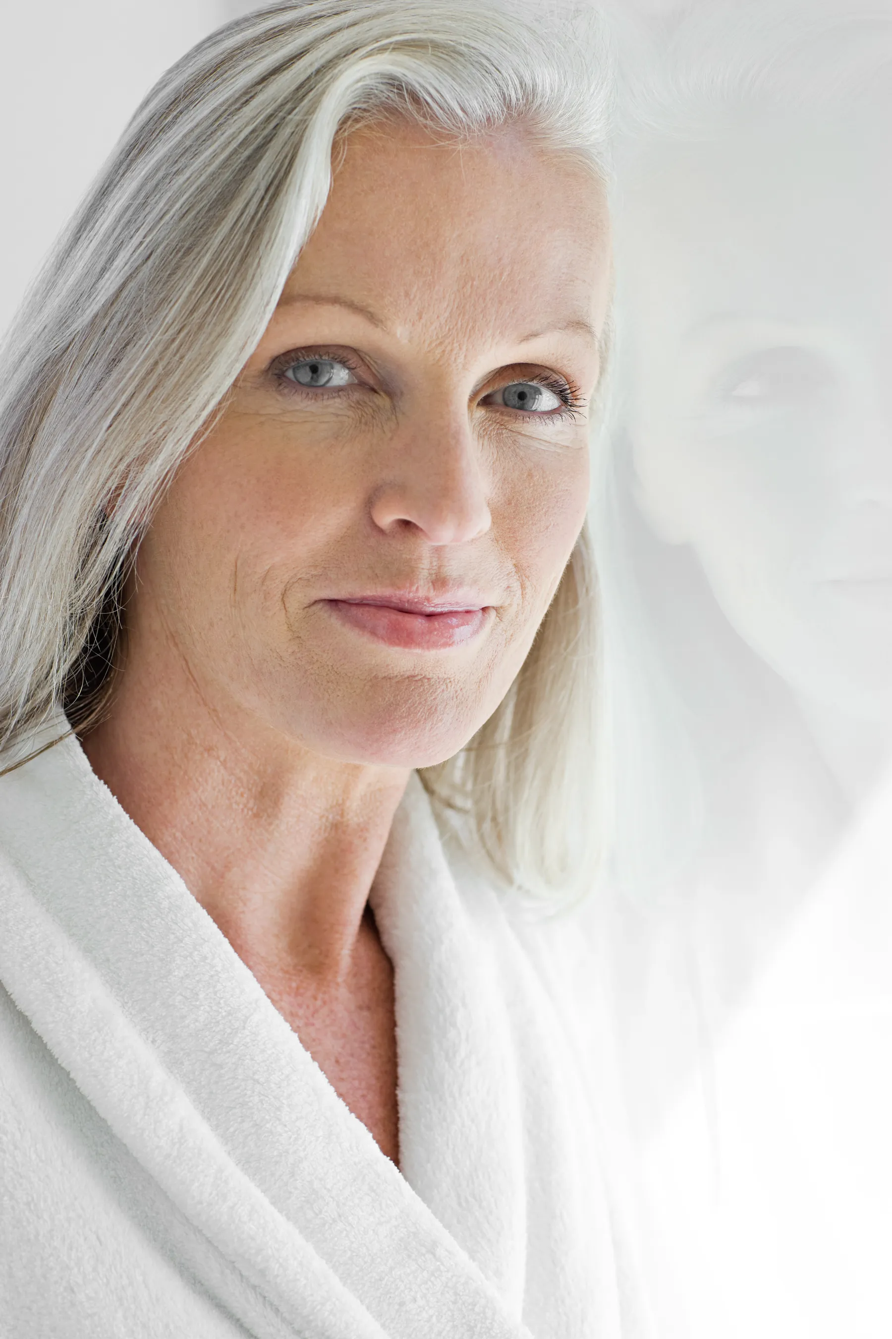 Close-up of a mature woman in white robe