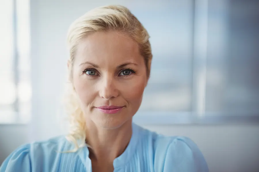 Close-up of woman smiling calmly at camera