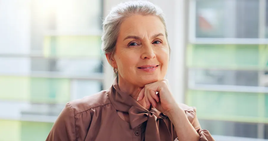 A confident senior woman posing with grey hair