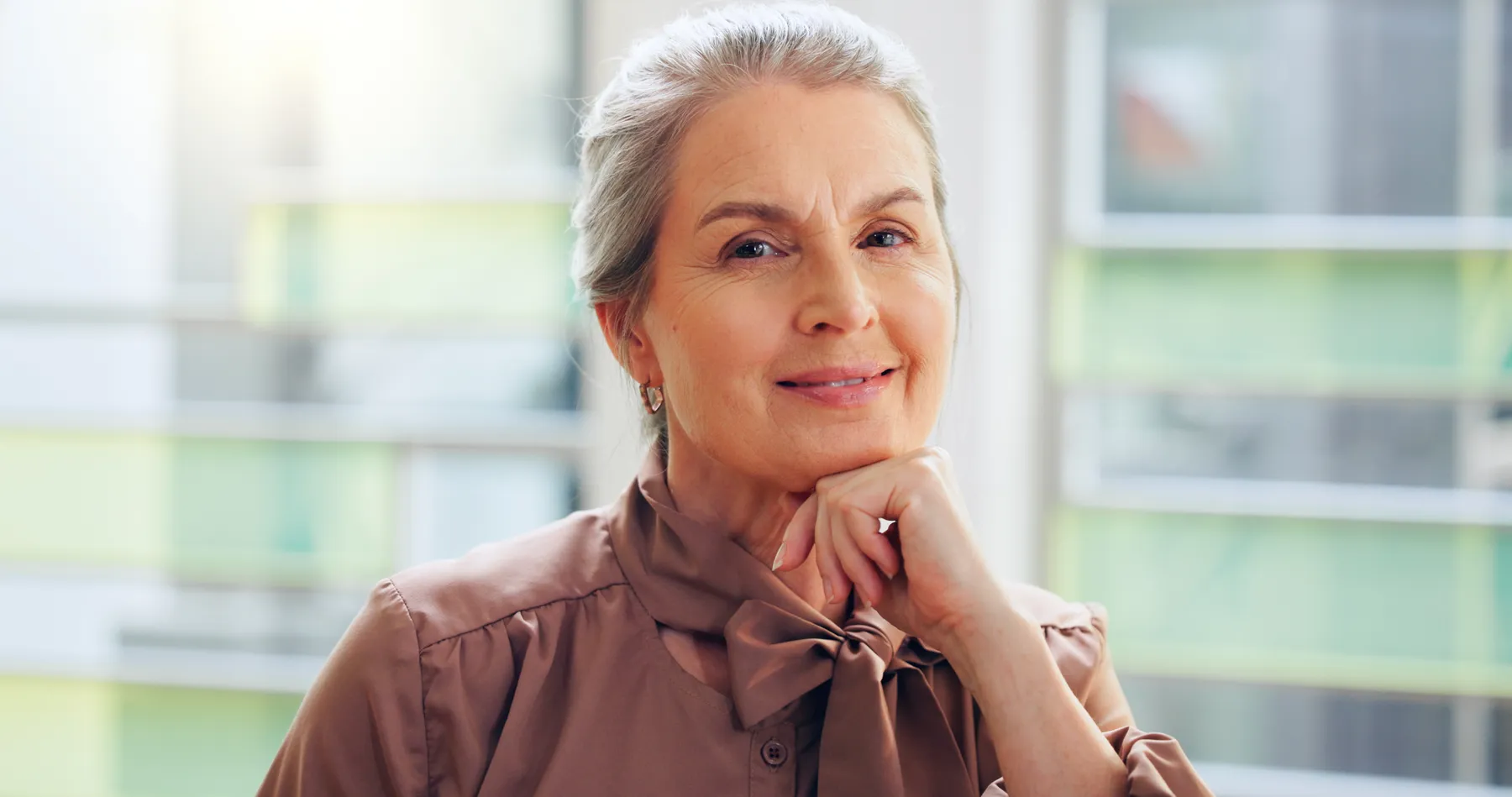 A confident senior woman posing with grey hair