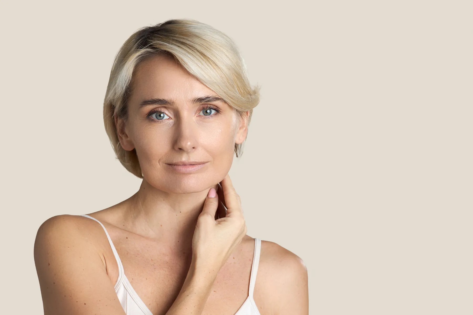 An elegant woman posing with hand on neck