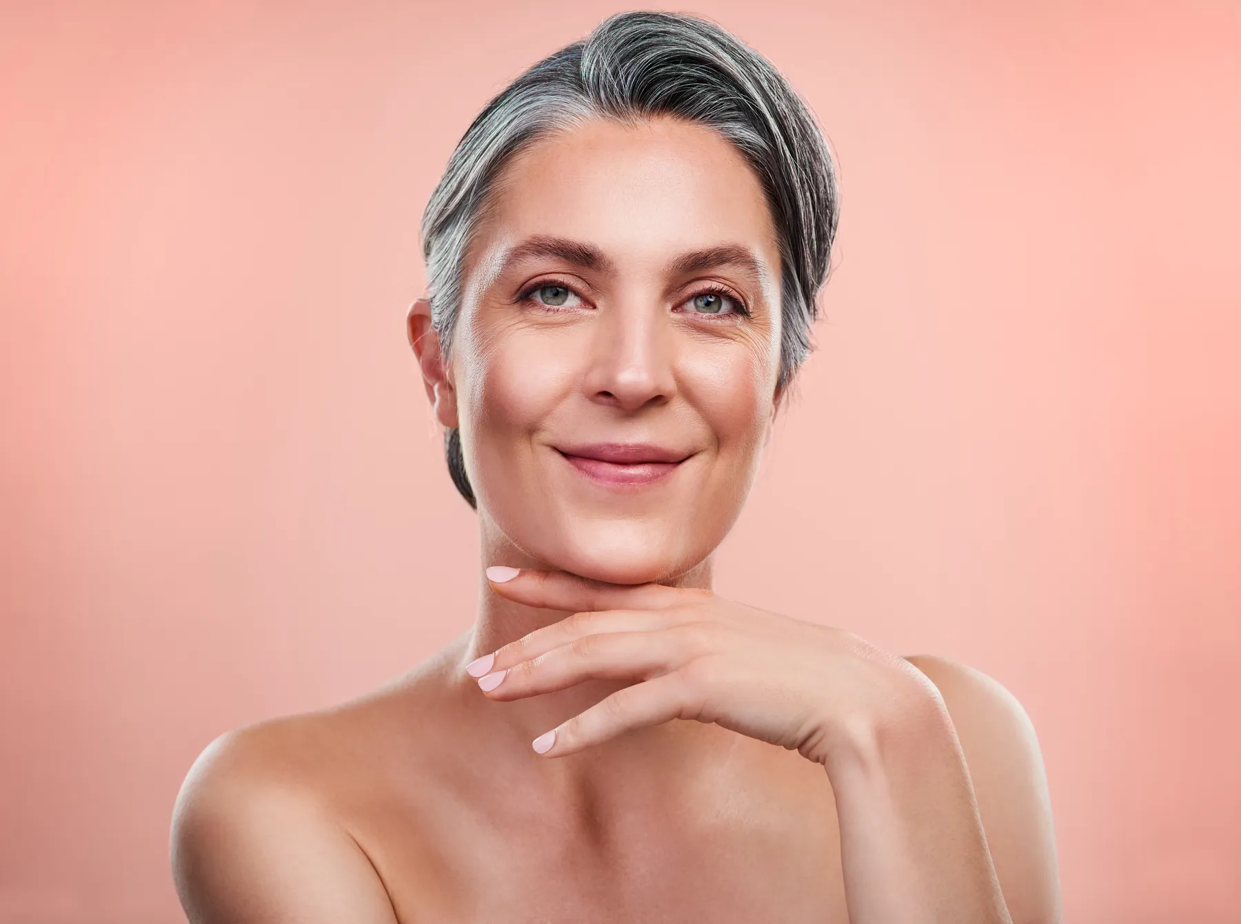 An elegant woman posing with hand under chin