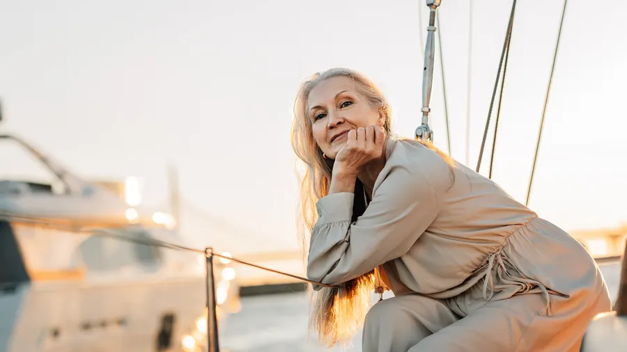 An elegant woman relaxing on yacht at sunset