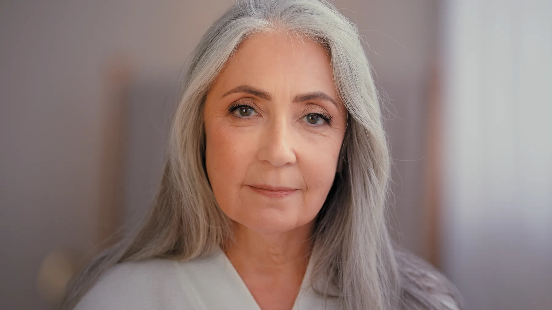 A mature woman portrait with long gray hair