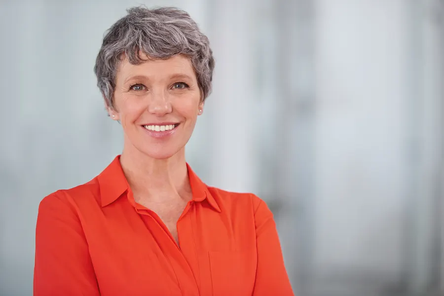 A professional woman smiling confidently in an
