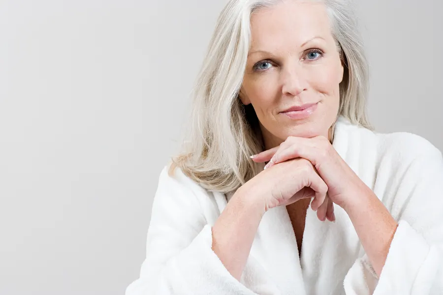 A relaxing woman in bathrobe with silver hair