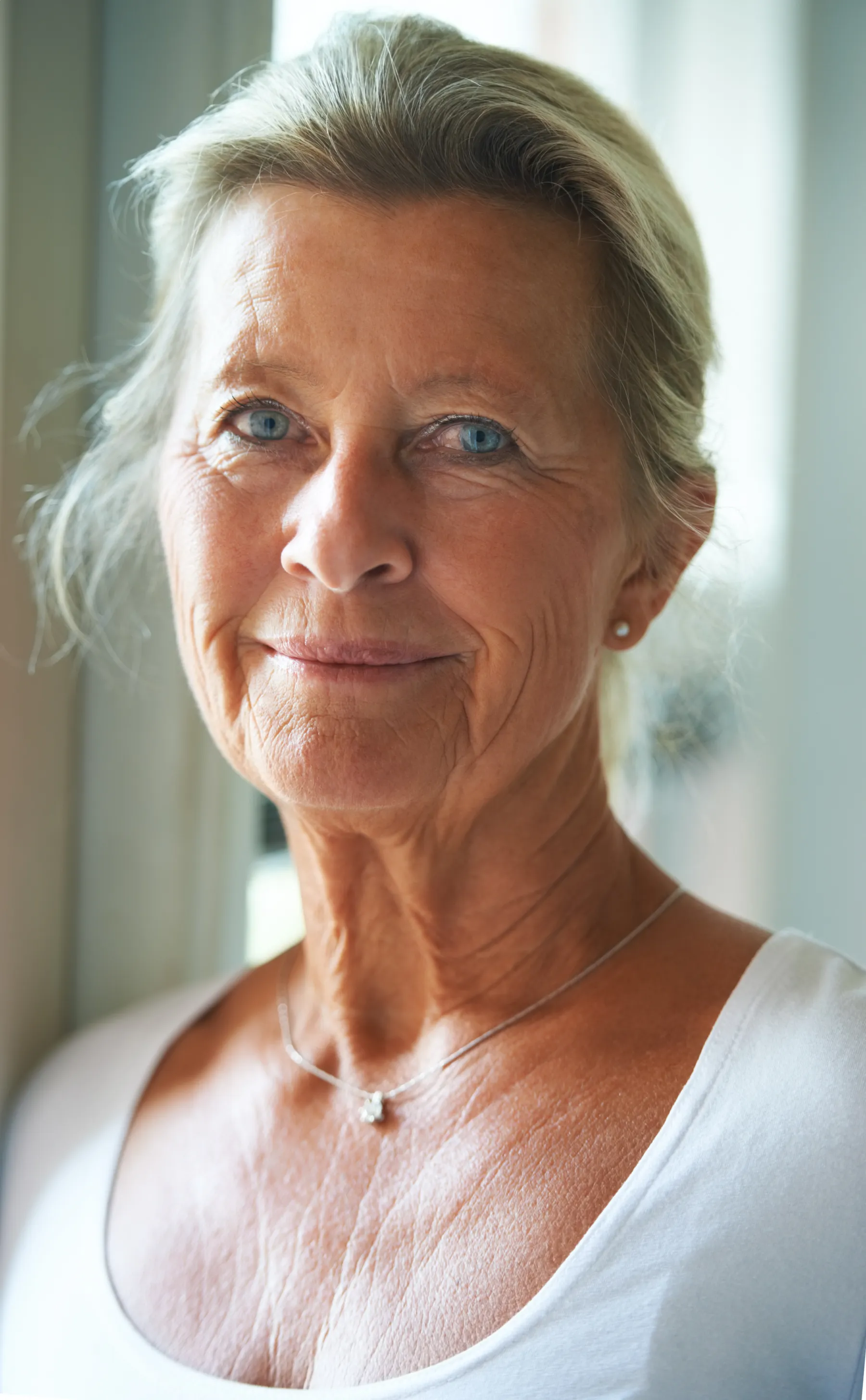 A senior woman portrait with gentle smile indoors