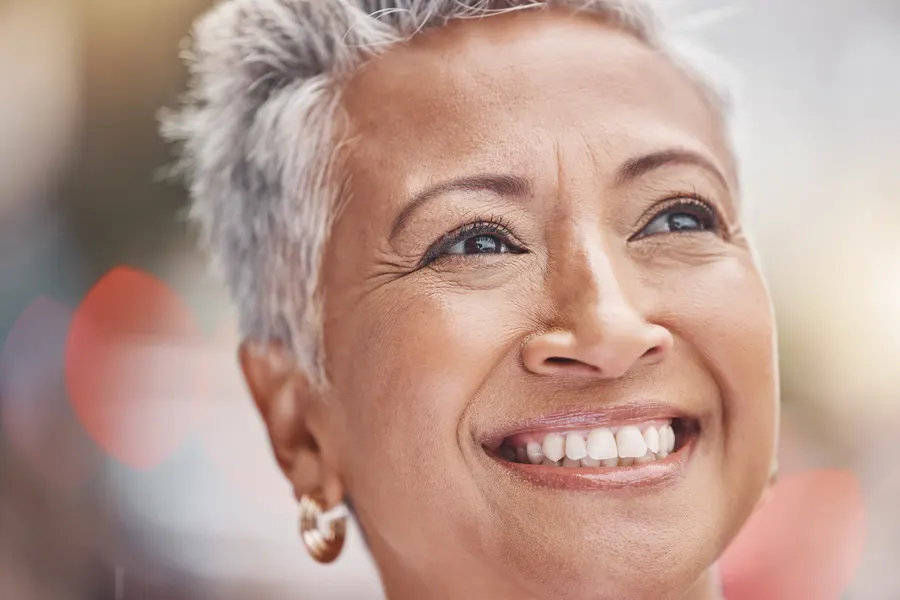 A smiling senior woman enjoys a sunny day