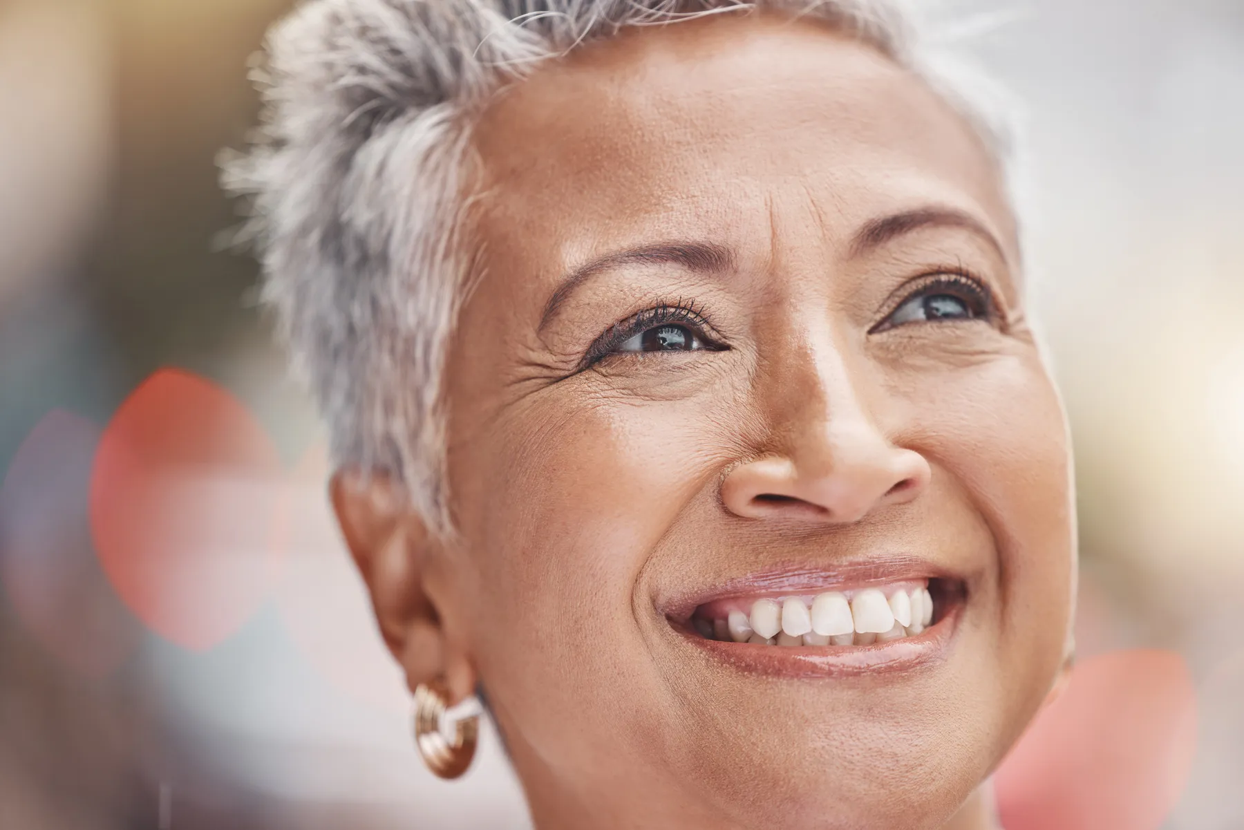 A smiling senior woman enjoys a sunny day