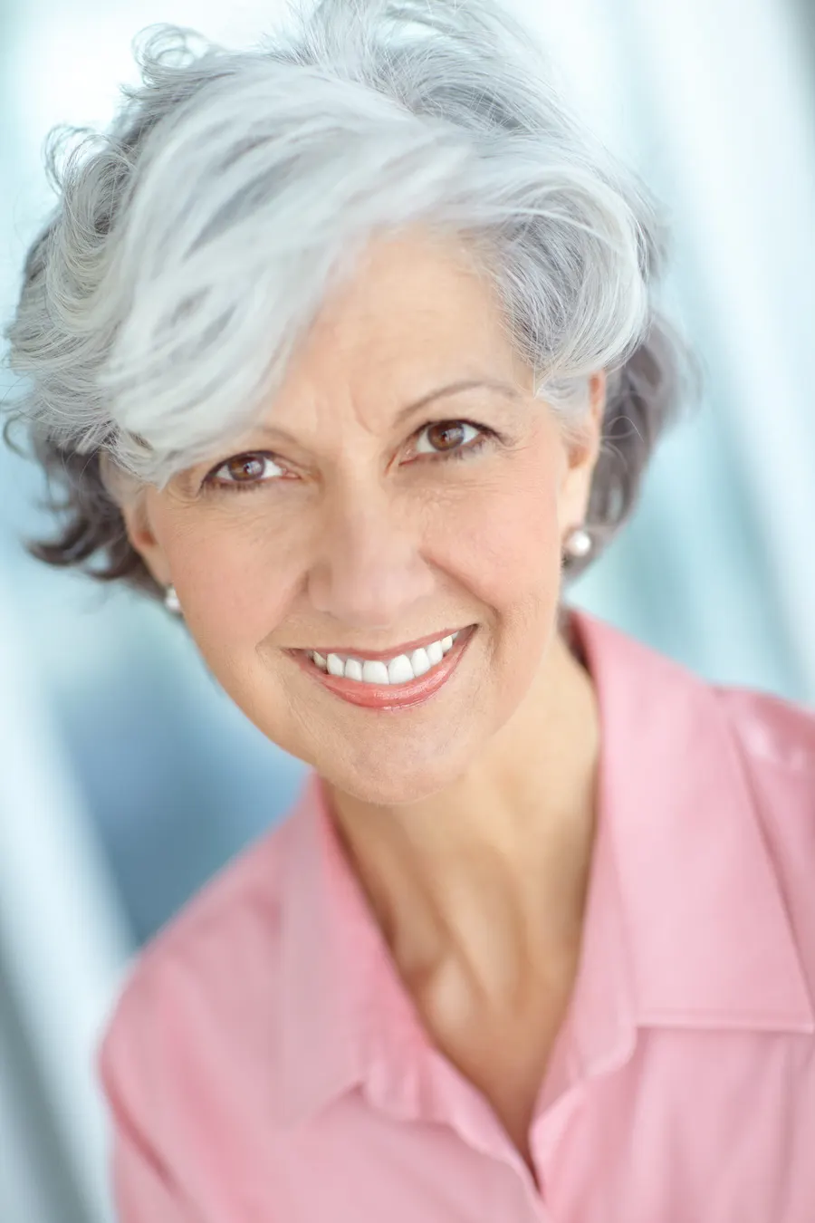 A smiling senior woman in pink shirt