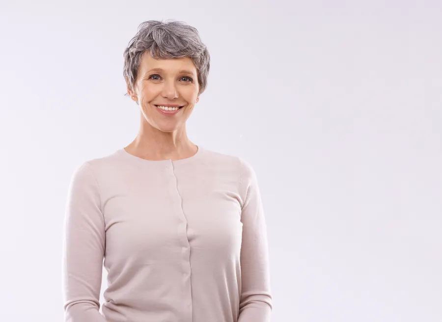 A smiling senior woman portrait on white background