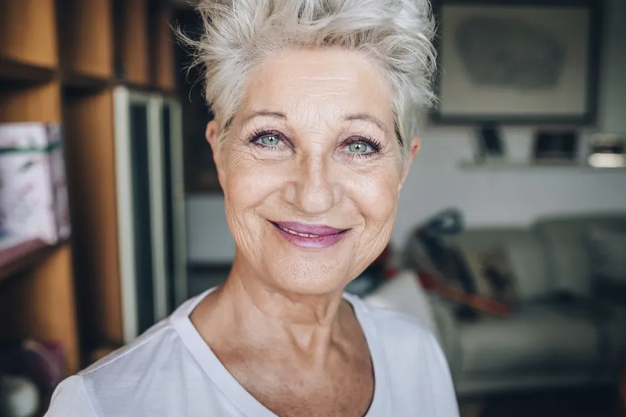 A smiling senior woman portrait with short silver