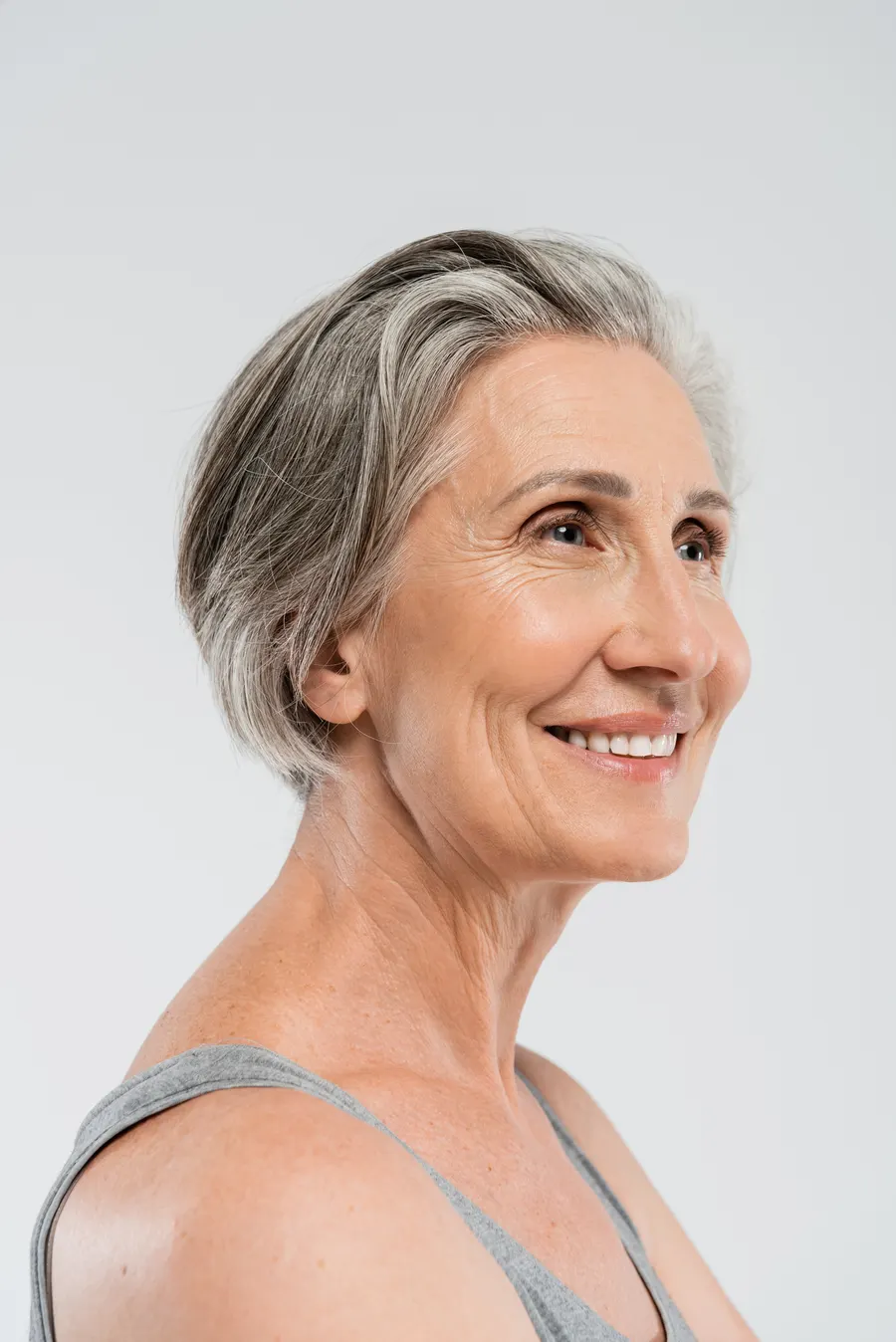 A smiling senior woman with gray hair posing