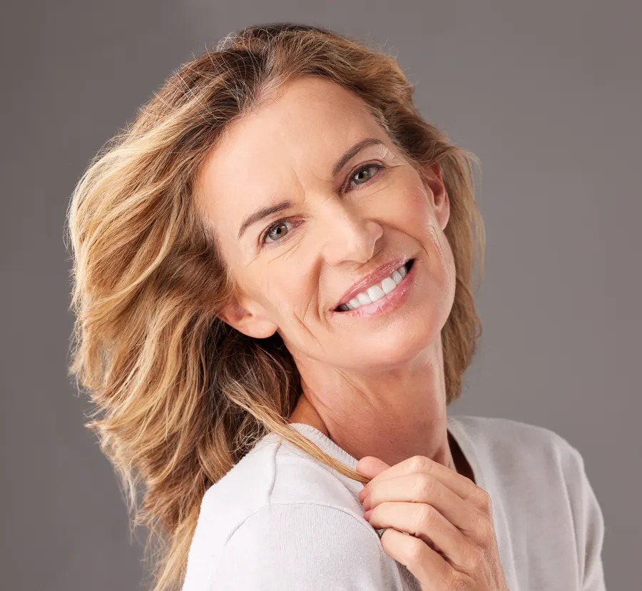 A smiling woman in portrait with flowing hair