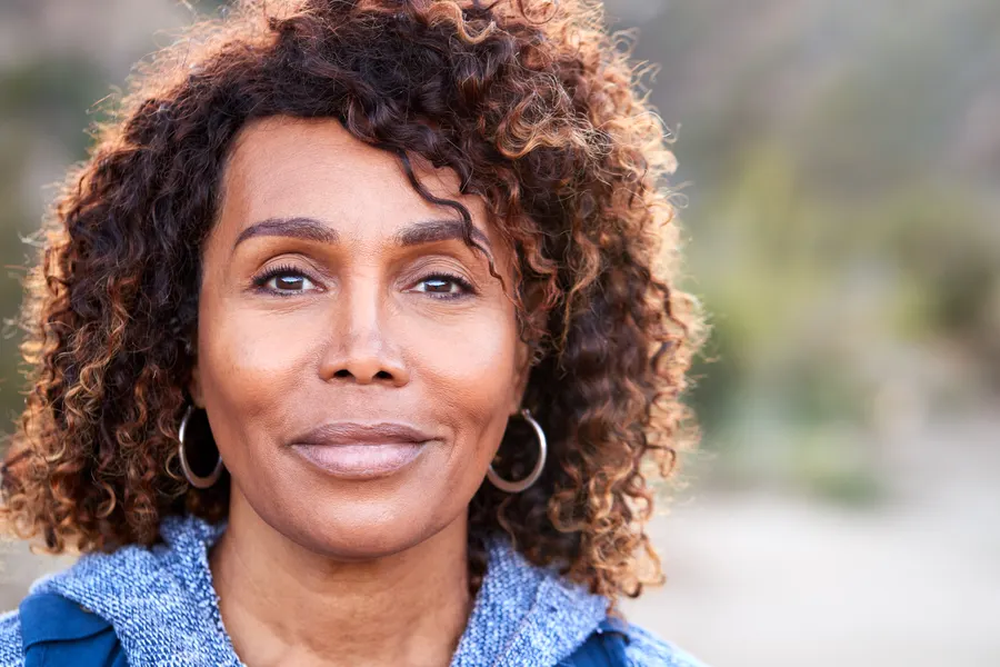 A smiling woman portrait outdoors in natural