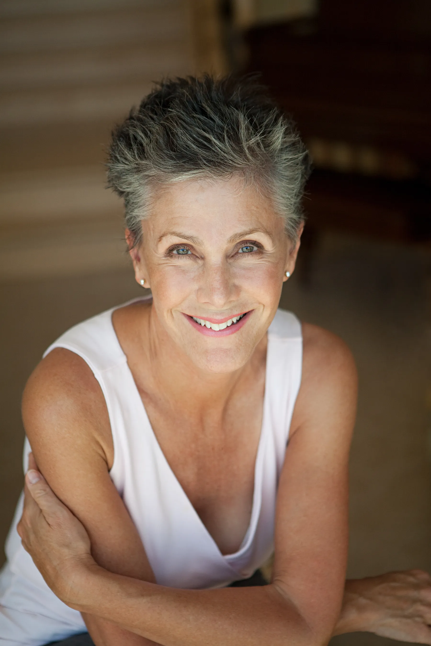A smiling woman portrait with short grey hair