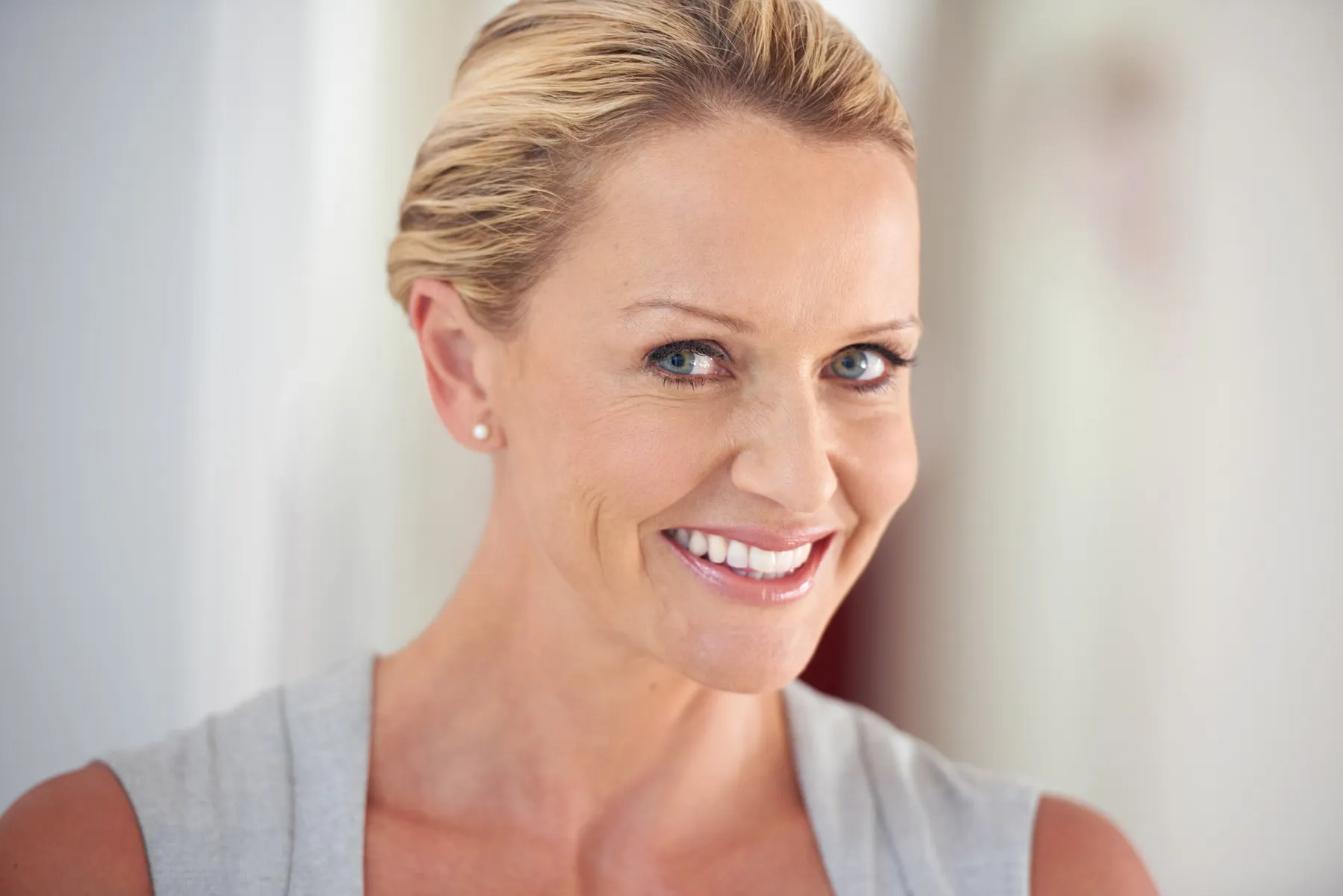 A smiling woman with blond hair close-up portrait
