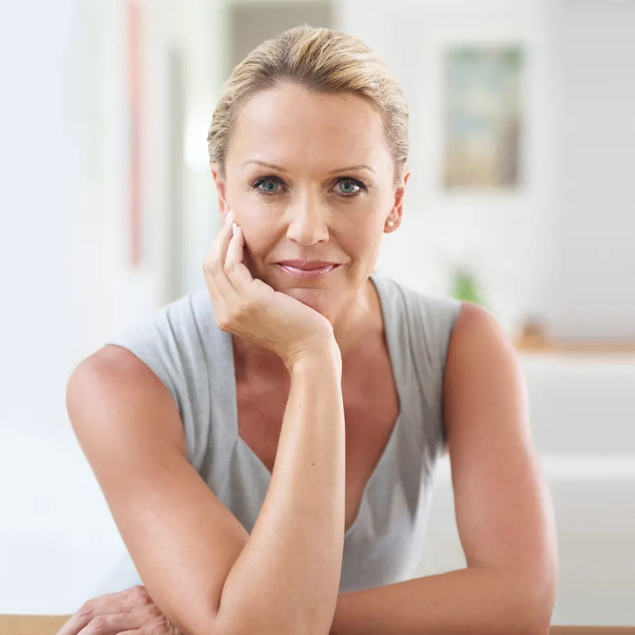 A smiling woman with blonde hair indoors