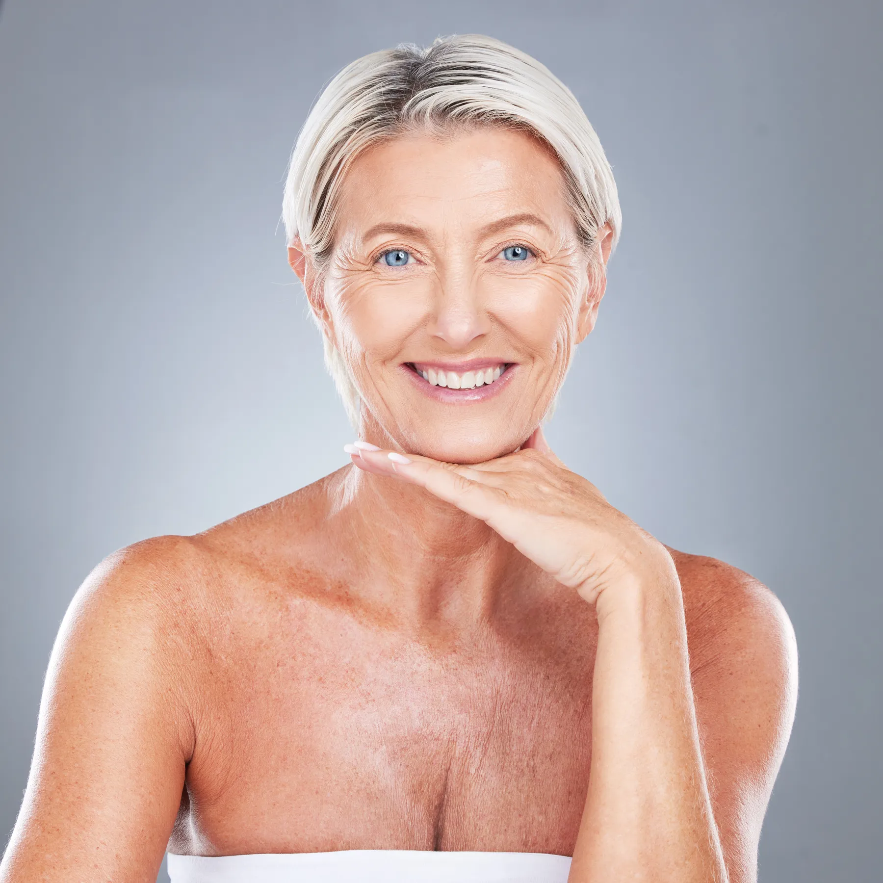 A smiling woman with short blonde hair posing