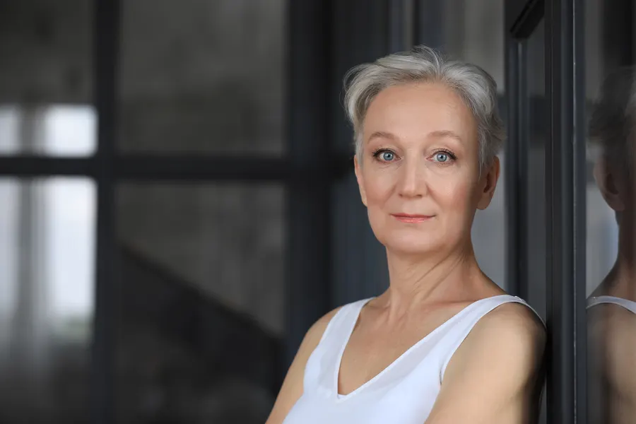 A thoughtful senior woman with short gray hair