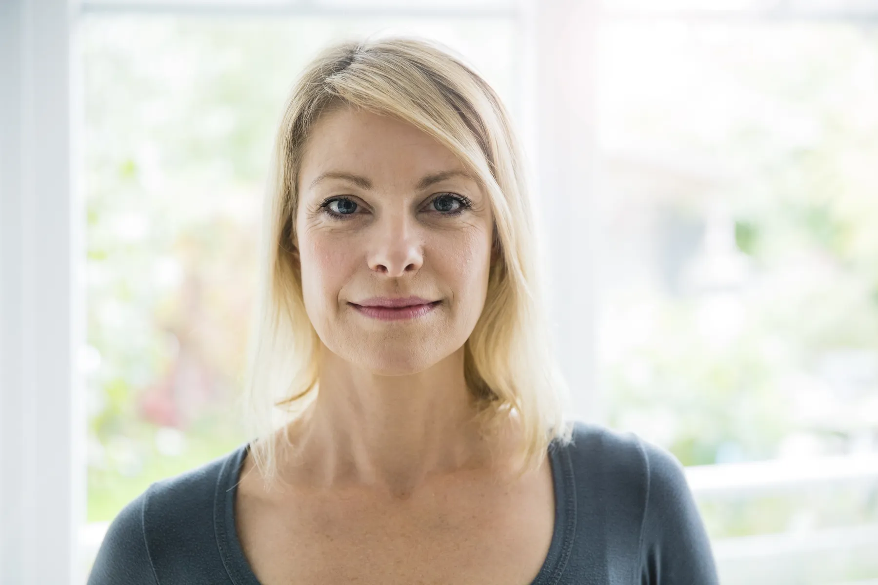 A woman poses for portrait in natural light