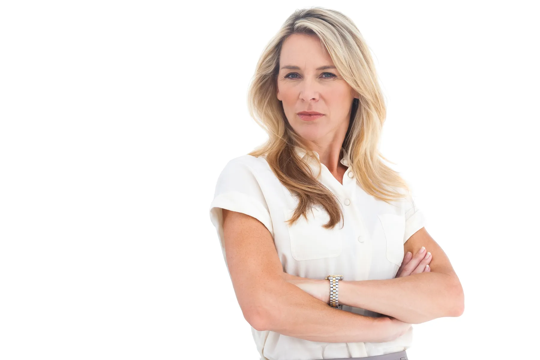 A woman posing with arms crossed wearing white top