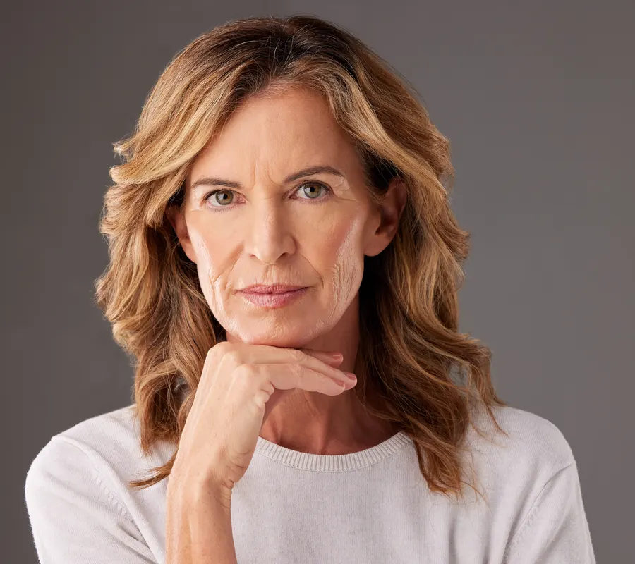 A woman posing with hand under chin