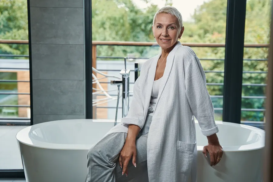 A woman relaxing in bathroom wearing robe