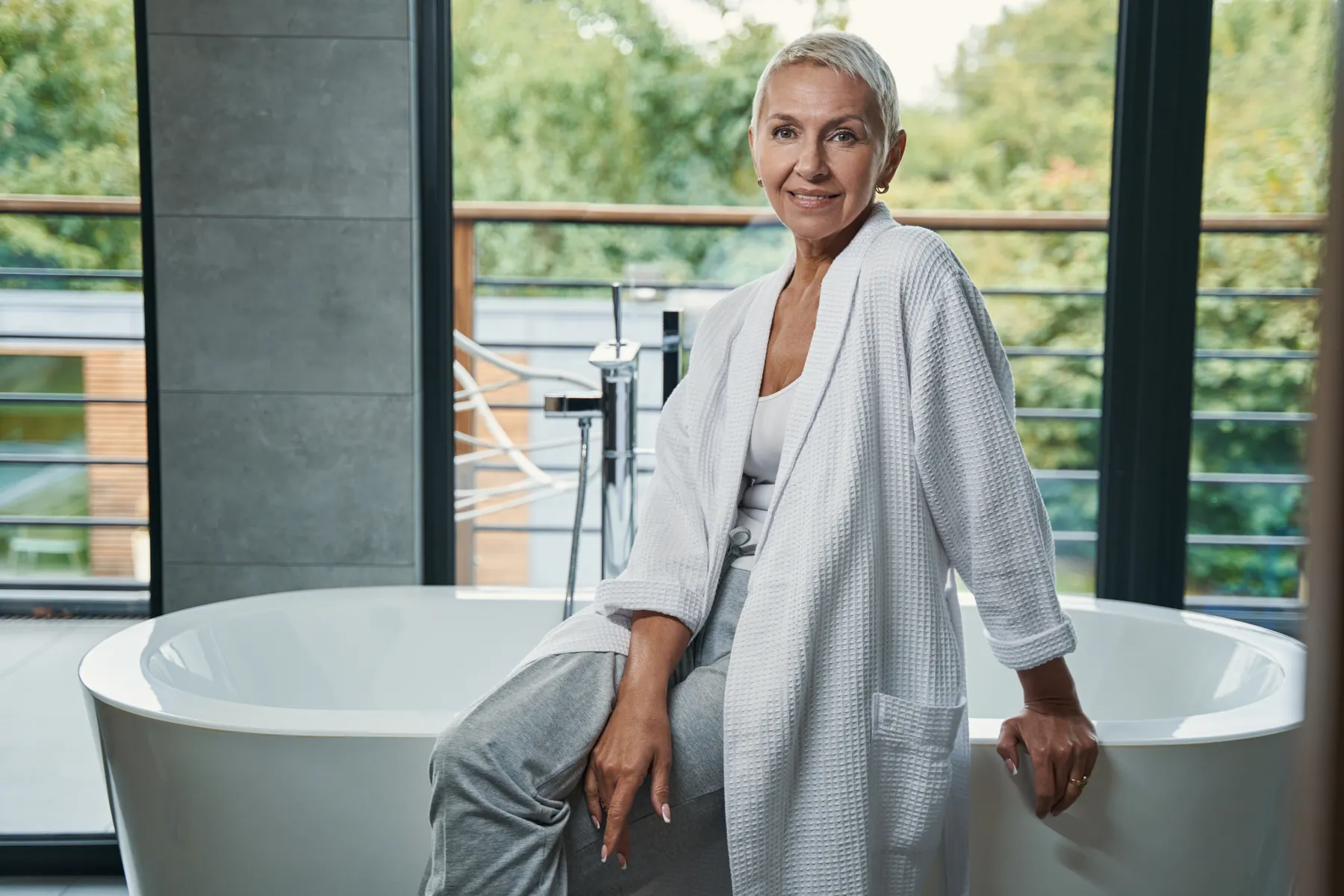 A woman relaxing in bathroom wearing robe