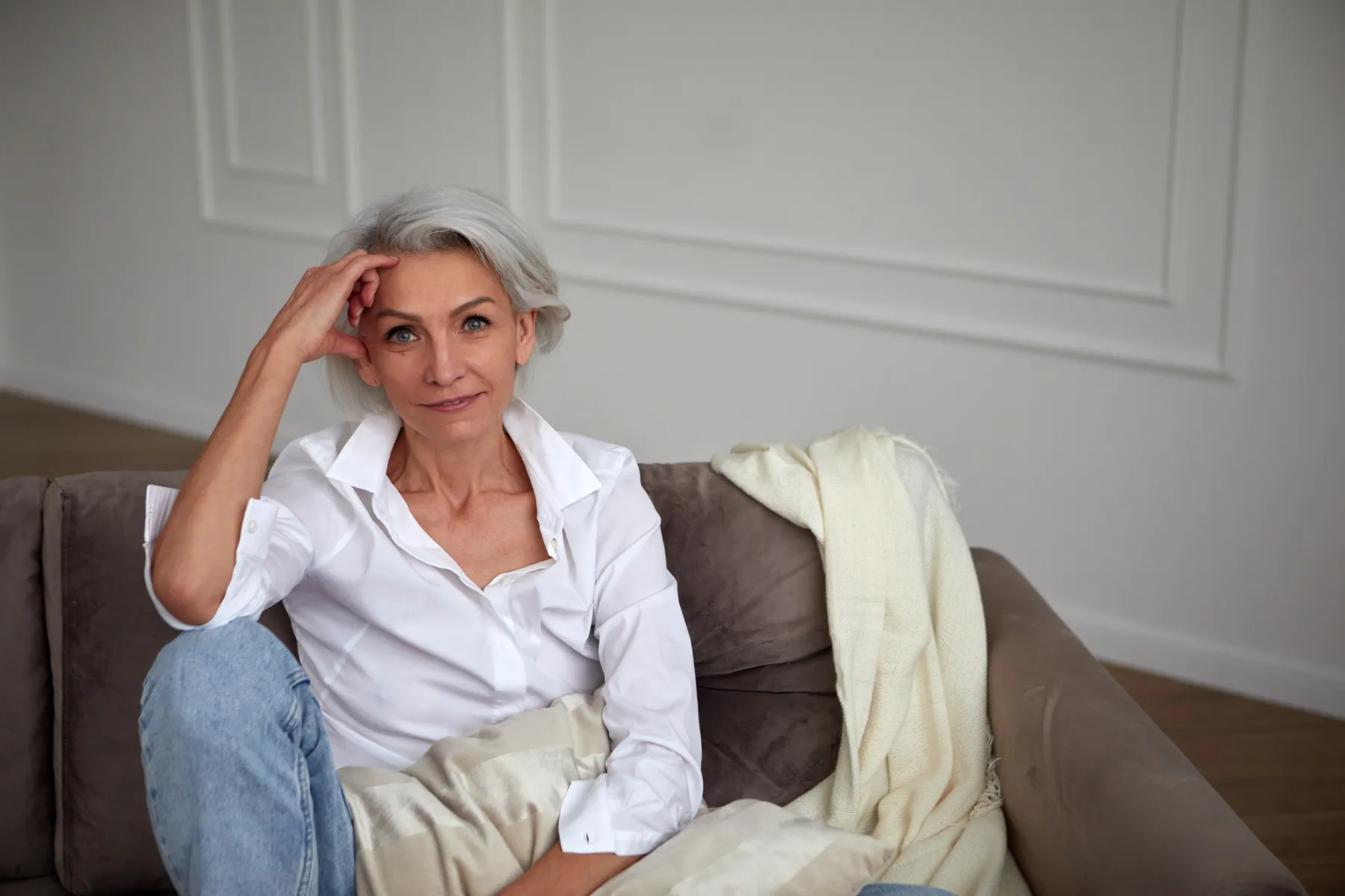A woman relaxing on couch at home indoors