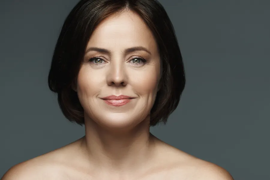 A woman with short brown hair posing in studio